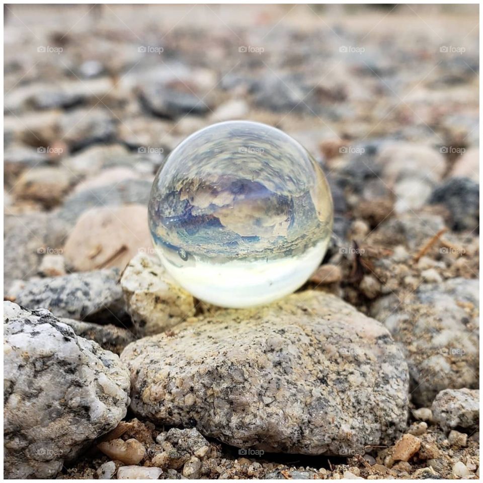 crystal ball sitting upon rocks in the desert