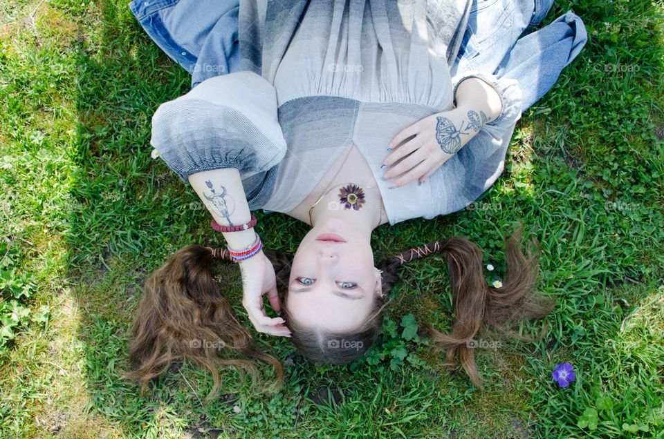 Portrait of Young Girl on Background of Daisies