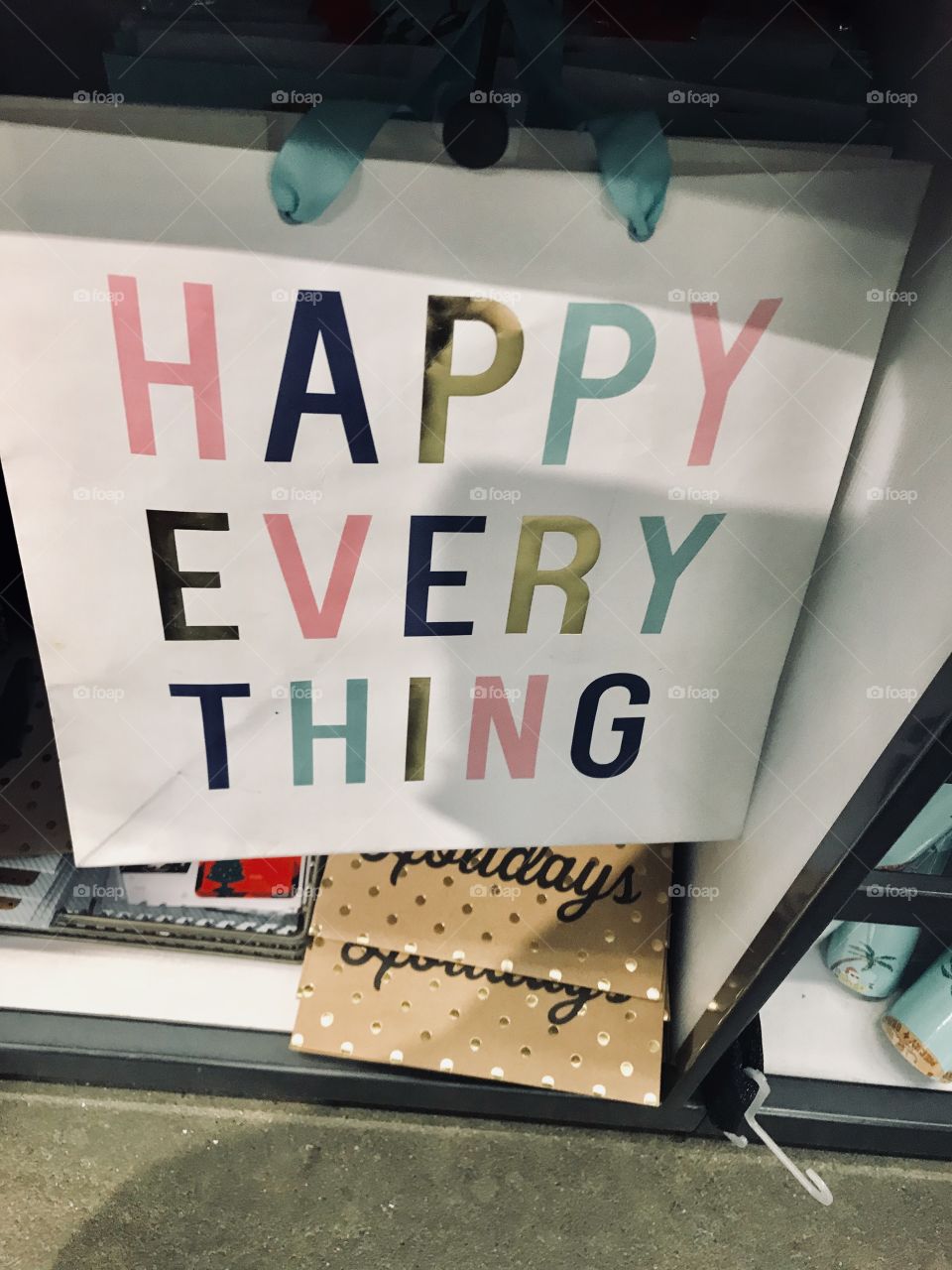 A beautiful and bright white gift bag saying happy everything on it at the department store in the USA America. 