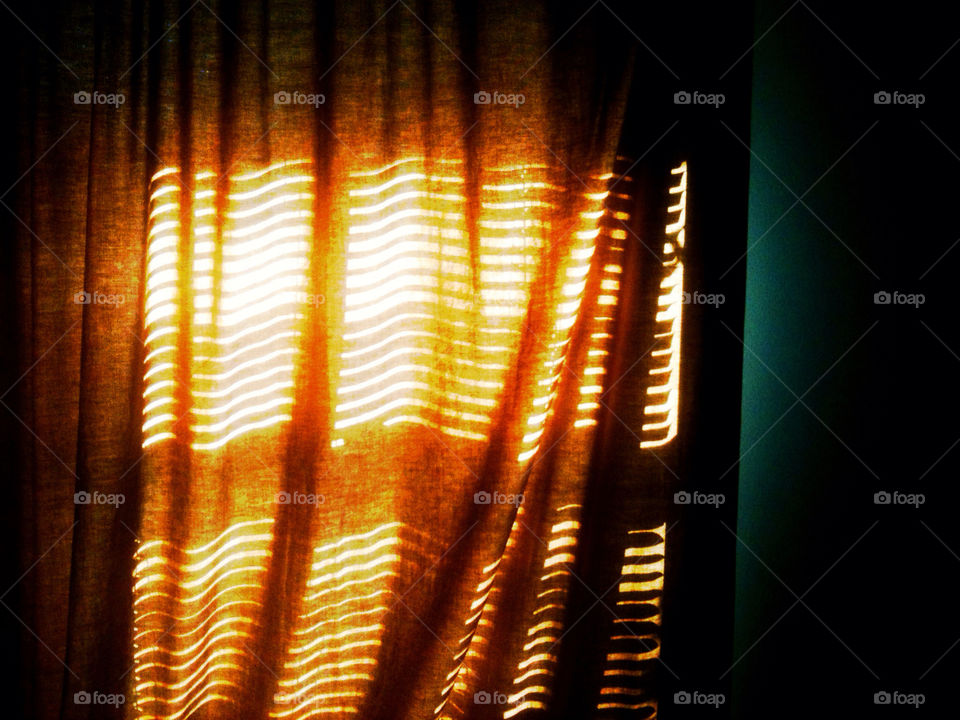 Sunlight coming in through a curtain.