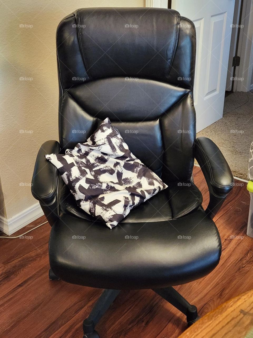 black office chair with pillow for working from home