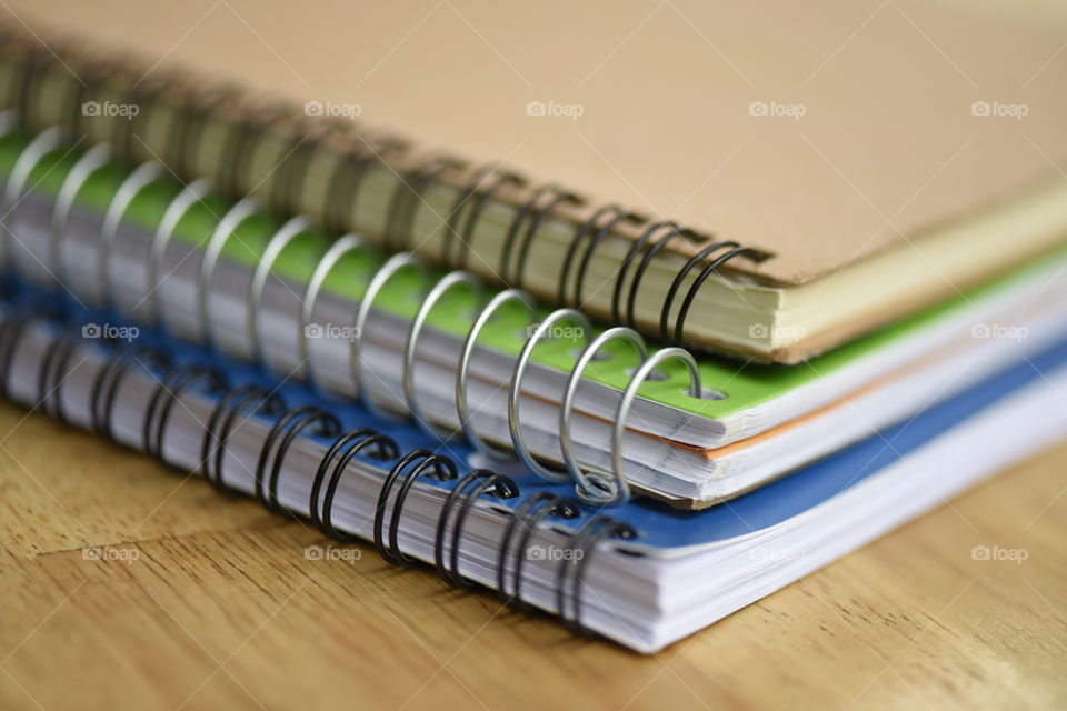 Three wire bound notebooks on my kids study table.