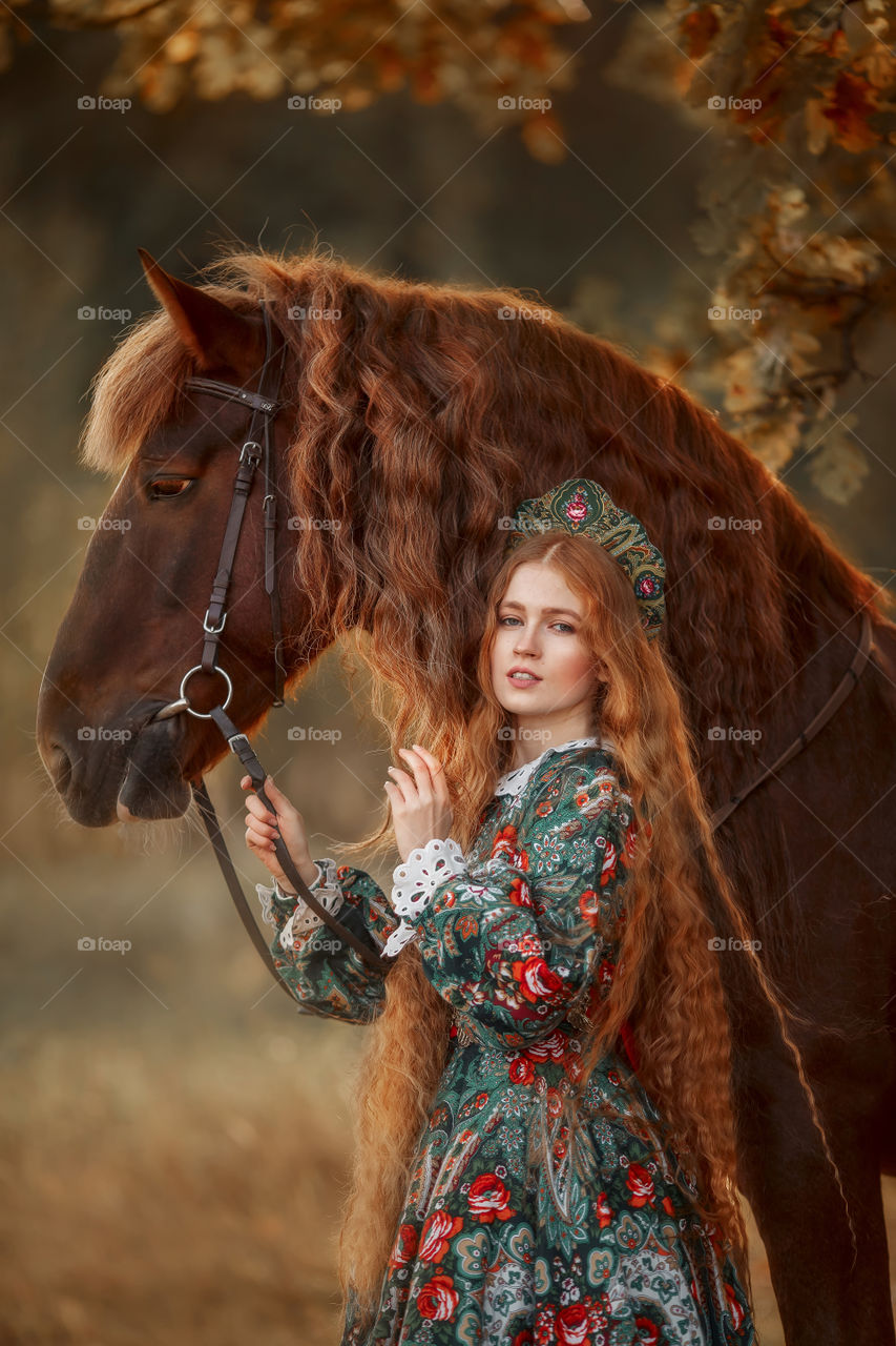 Beautiful woman in Russian costume dress with Vladimir draft horse portrait