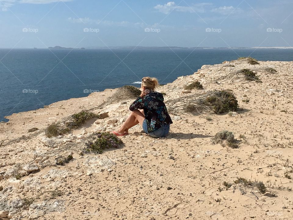 Beach cliffs, woman sitting on beach cliff south Australia coffin Bay Area 