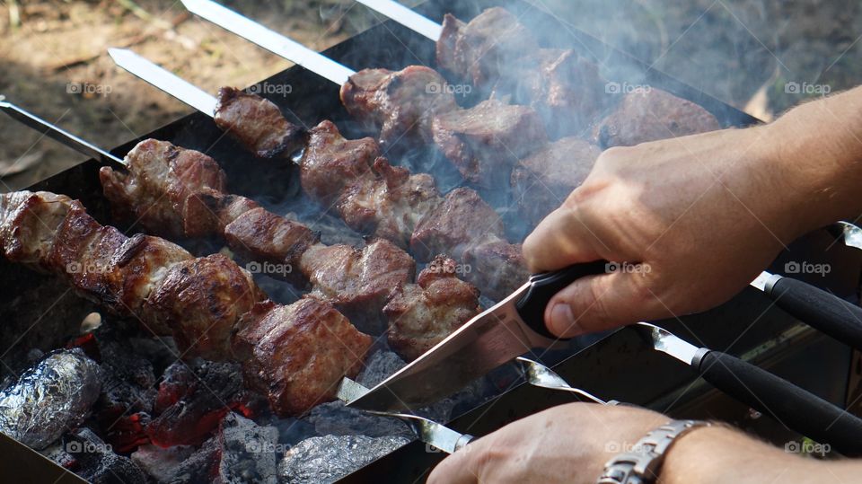 Kebabs preparing over charcoal grill