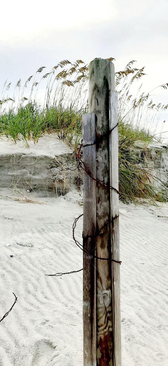 damaged sand fence from tropical storm