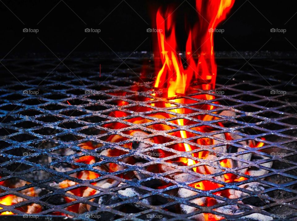 On the grill. A picture of fire building before food is put on the grill.