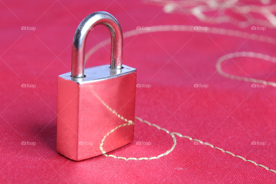 miniature lock on red background