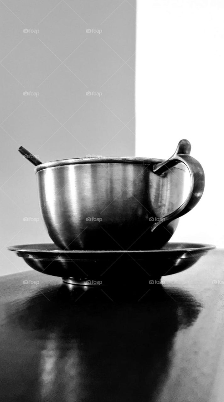 Tin cup waiting for the tea to be ready.