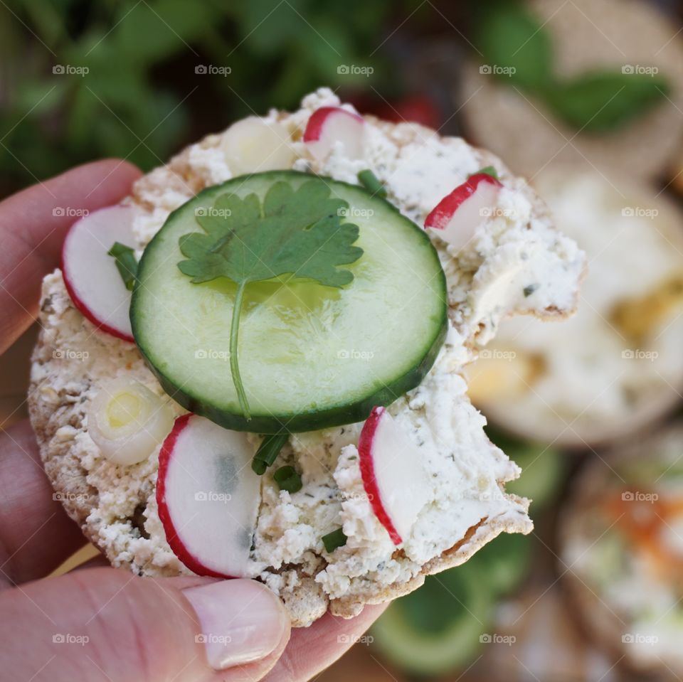 Healthy snack ... rice cracker with cream cheese, cucumber, radish and spring onion 