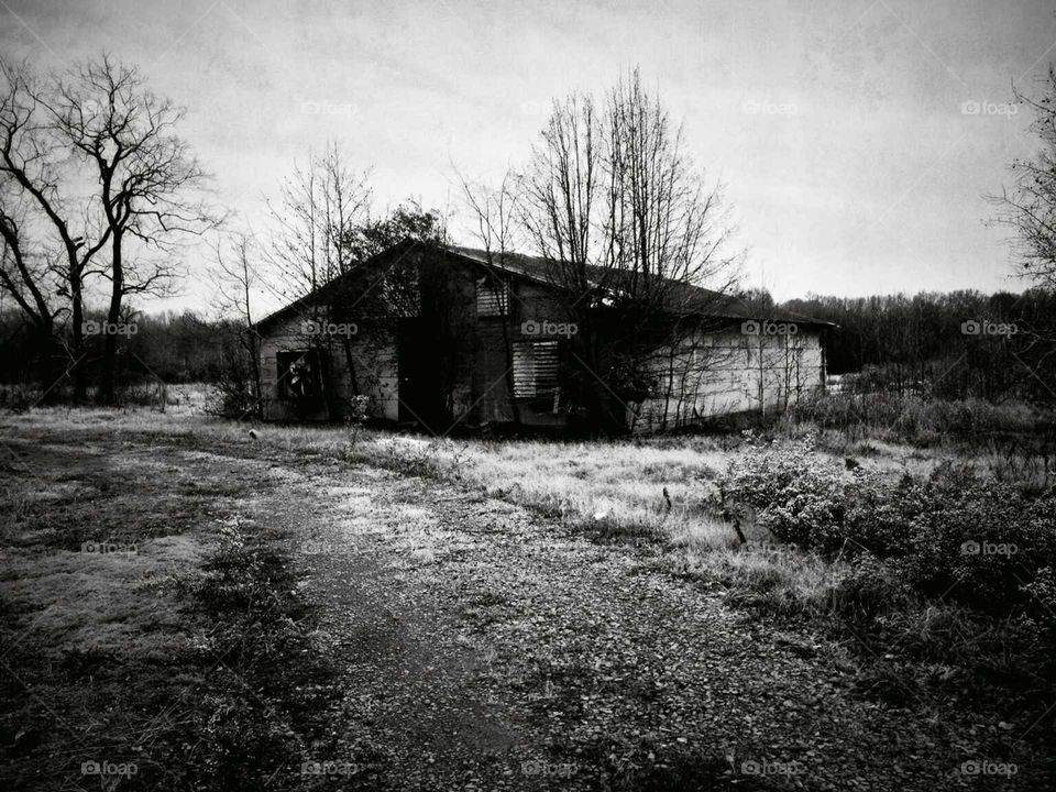 An eerie photo in B&W of an old barn on a rural Arkansas farm
