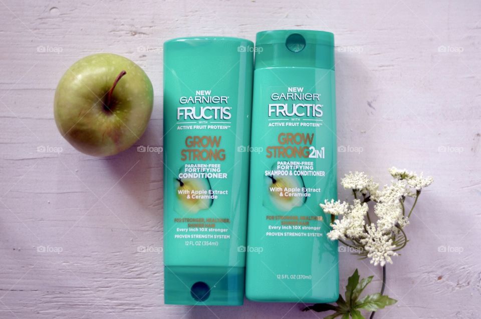 Garnier grow strong conditioner and shampoo Flat lay on a white background