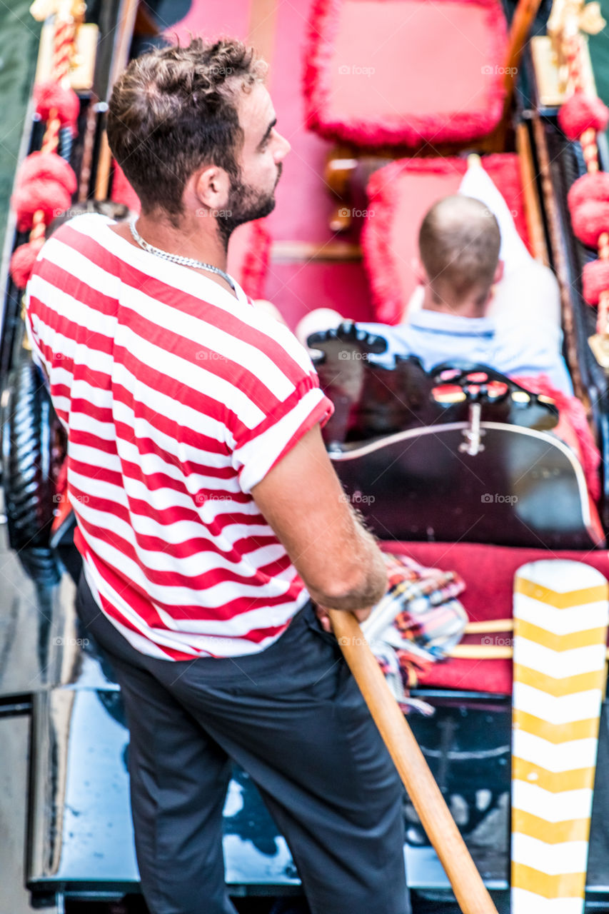 Gondolier Giving A Ride With Gondola In Venice, Italy
