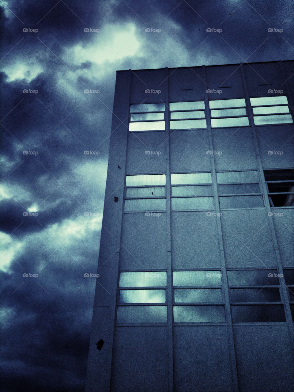 Reflection of storm clouds in the windows of an office building