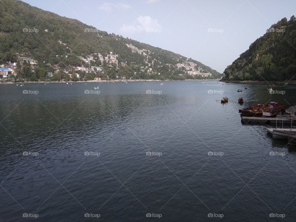 Nainital - it is a Himalayan resort town in the Kumaon region of India’s Uttarakhand state, at an elevation of roughly 2,000m. Formerly a British hill station, it’s set around Nainital Lake, a popular boating site with Naina Devi Hindu Temple.