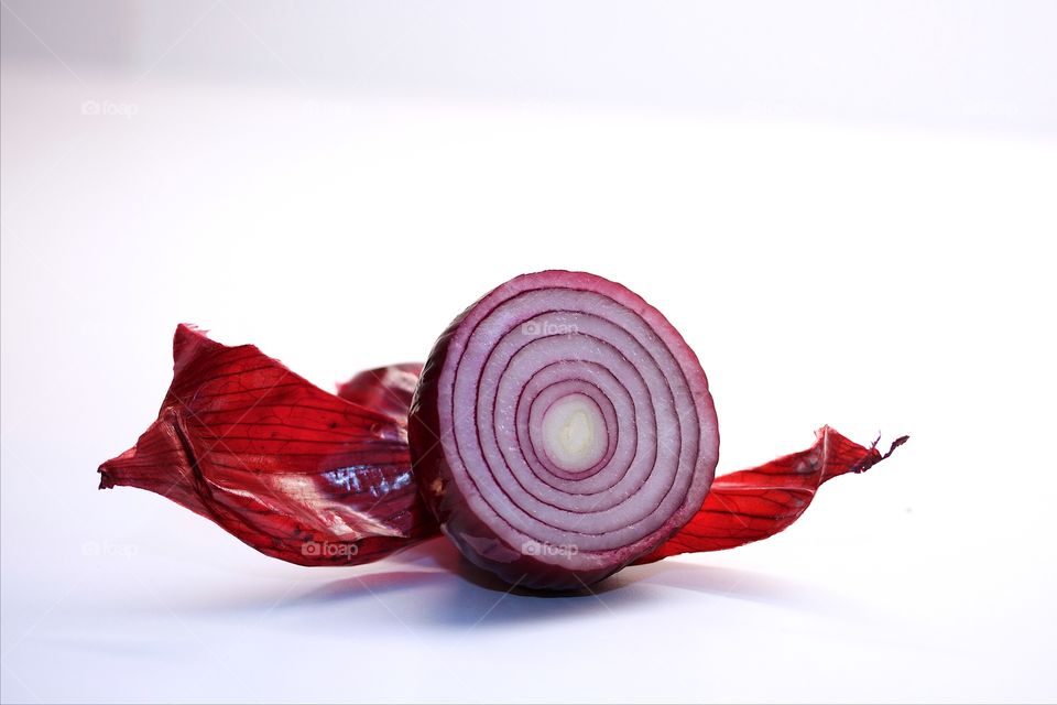 Slice of onion on white background