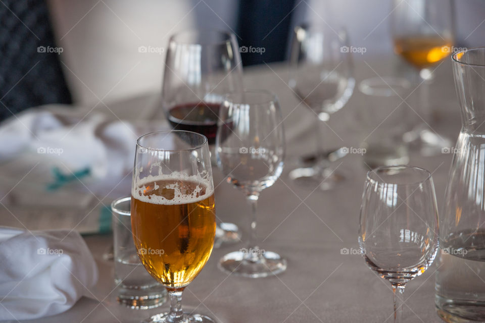 beer mugs and wine glasses on a dinner table at a party