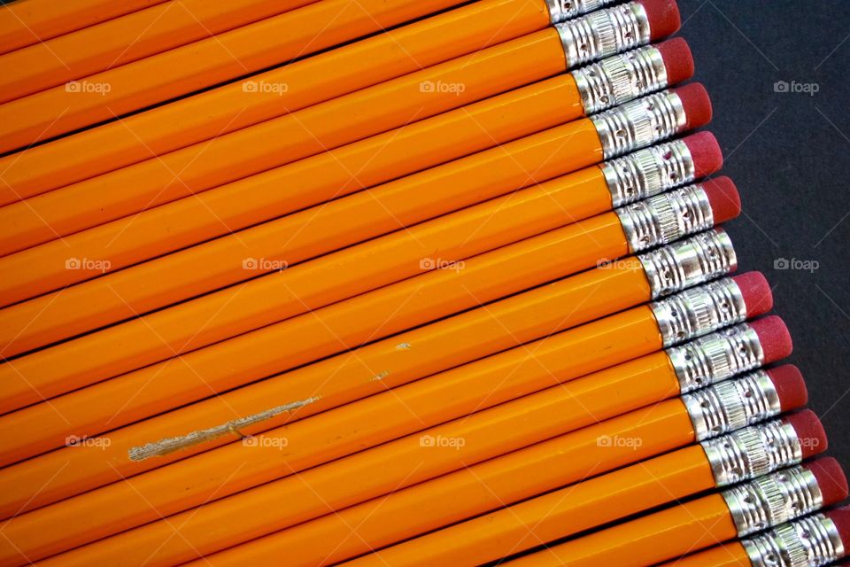 One broken pencil among perfect new pencils 