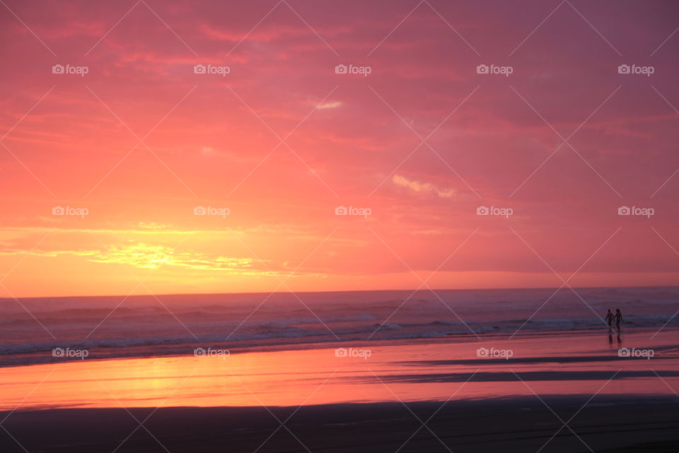 pink sunset  reflecting on the west coast shores of New Zealand