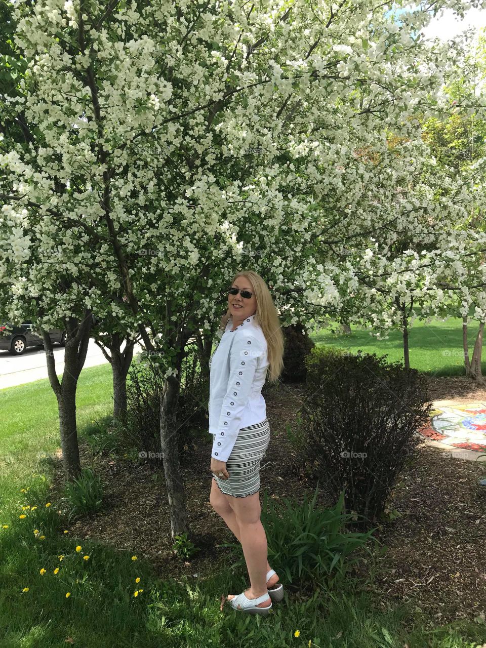 Woman wearing White Jacket and Flowering Trees