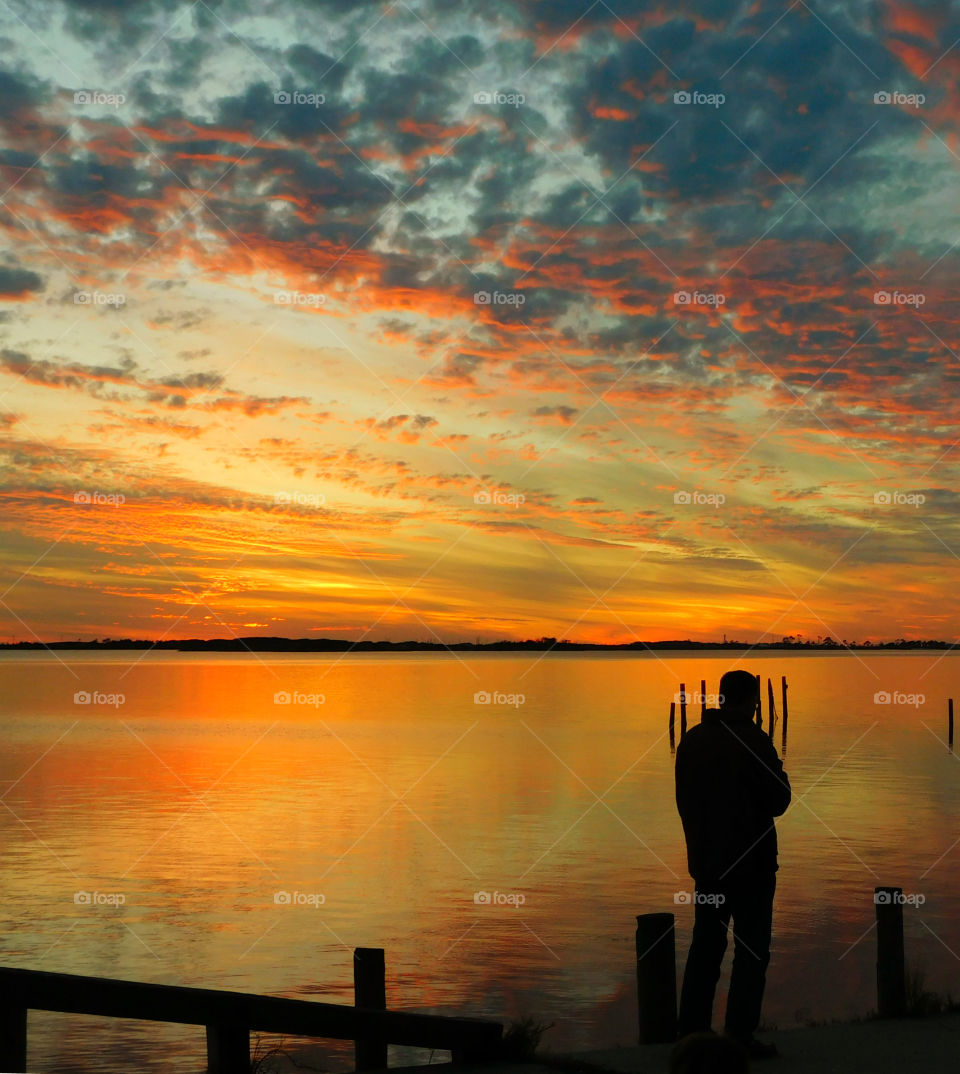 Silhouette of a man at seaside during sunset