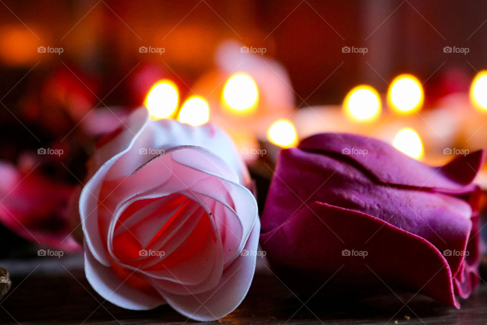 Romantic candles and purple and red flowers
