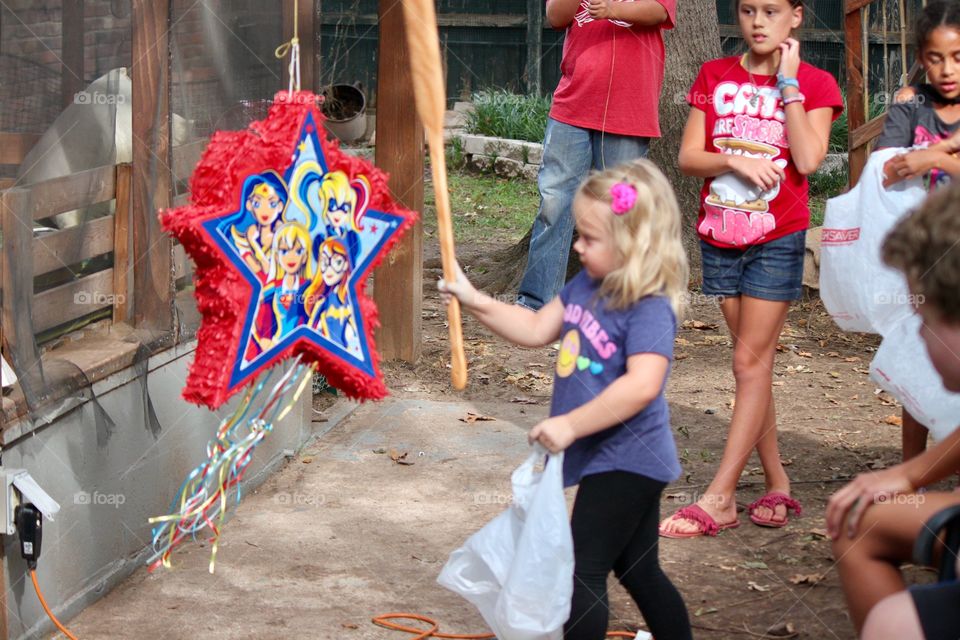 Little Girl Hitting a Pinata