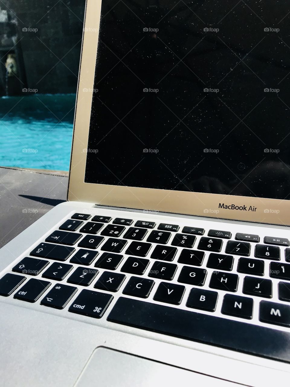 Apple MAC book by the pool 
