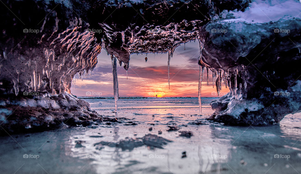 winter sunrise over the frozen se, glamorous ice formations, soft focus background