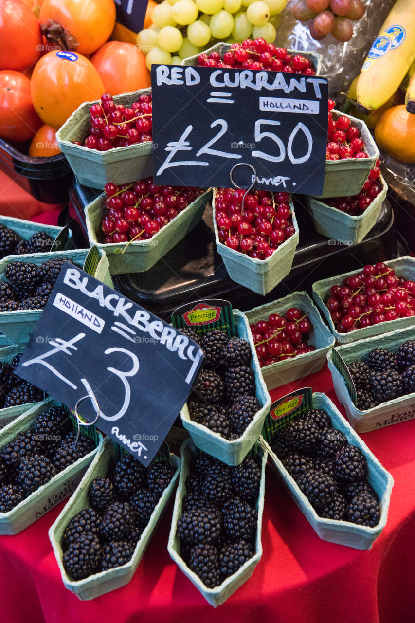 Blackberry and Red Currant at fruit stand at the Food market Borough Market in London.