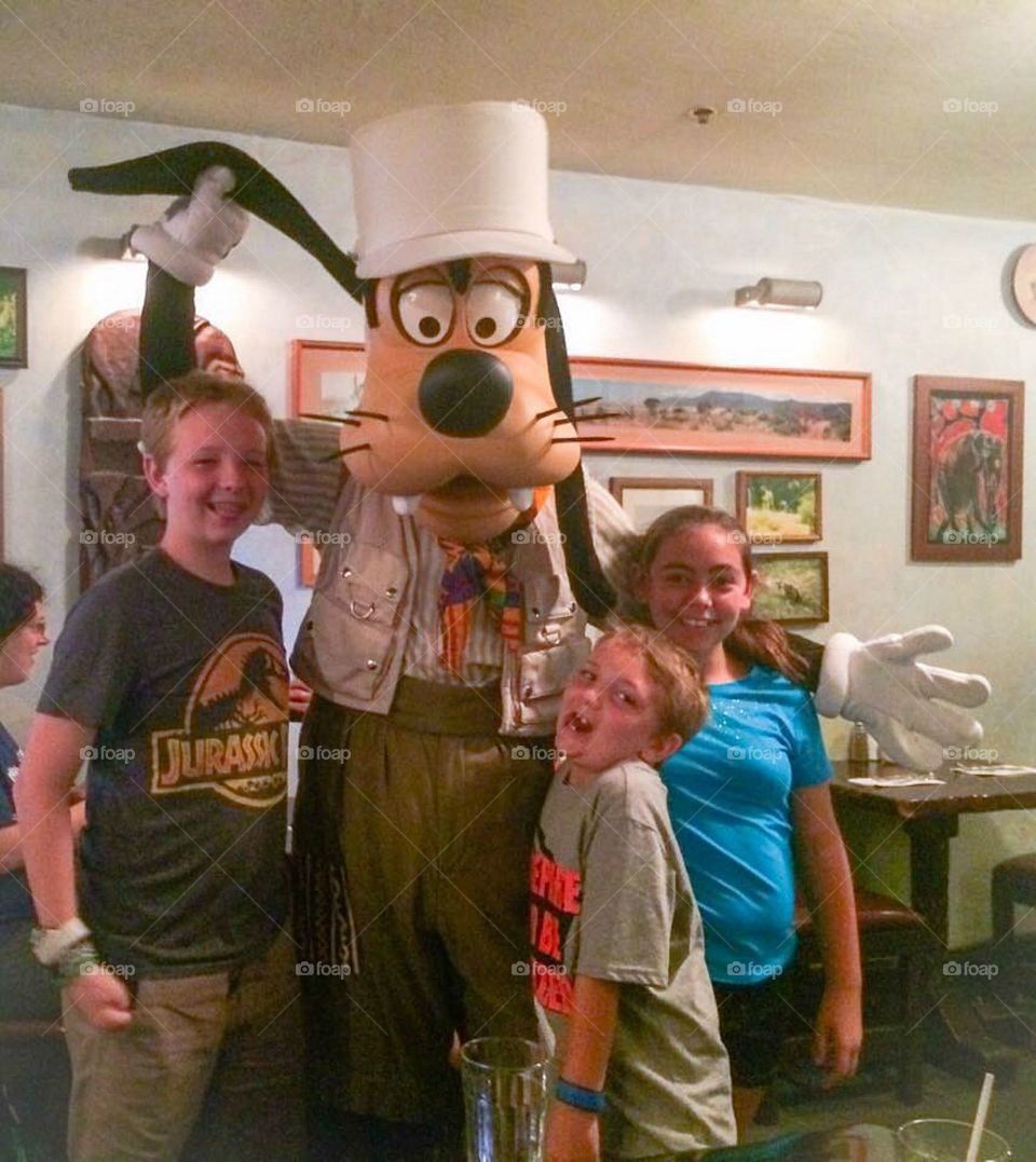 Children with a person wearing dog head