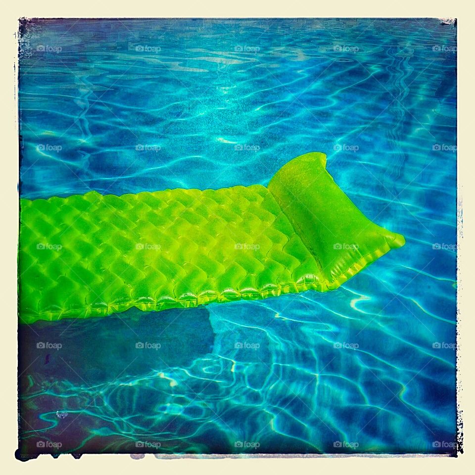 Air mattress floating in pool