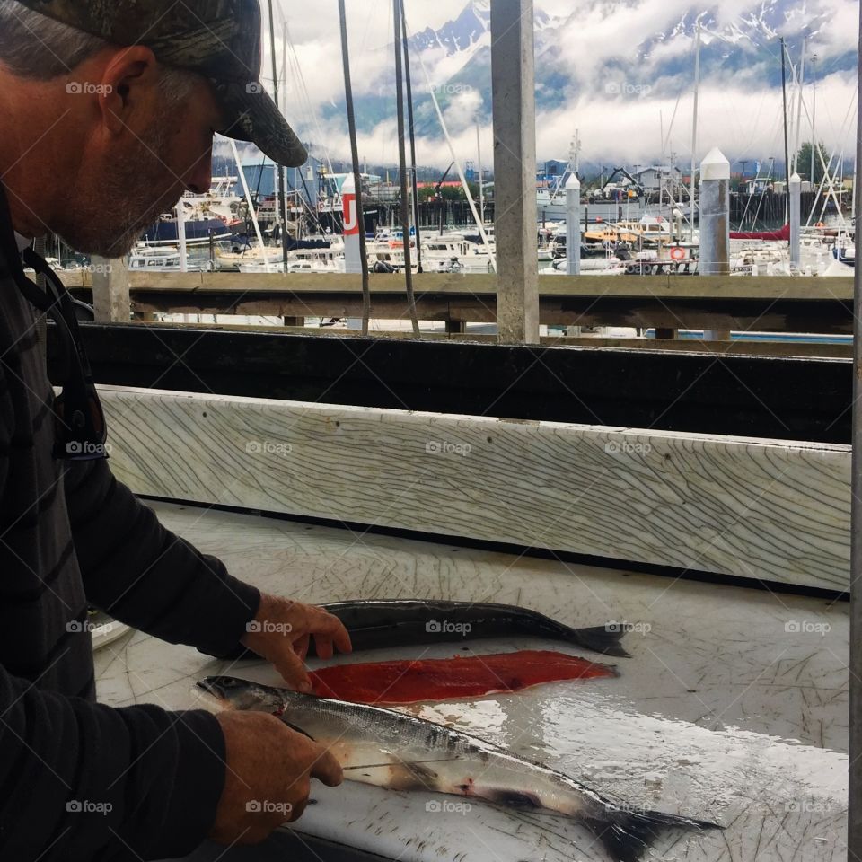 Close-up of a man cutting fish