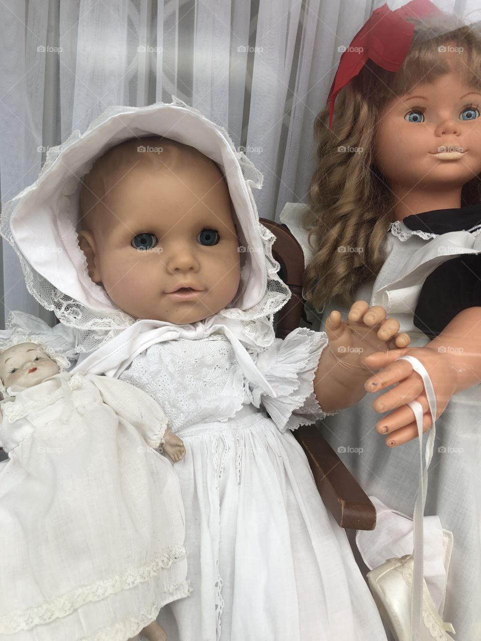 These two dolls are dressed in clothes that a photographer would have recommended in the early 19th century.