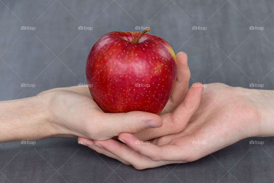Woman's hand holding red apple