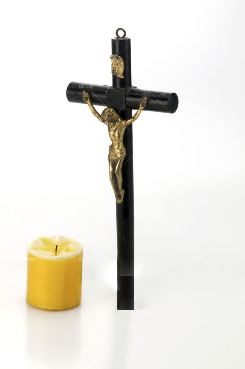 Jesus Christ on the cross with candle and white background