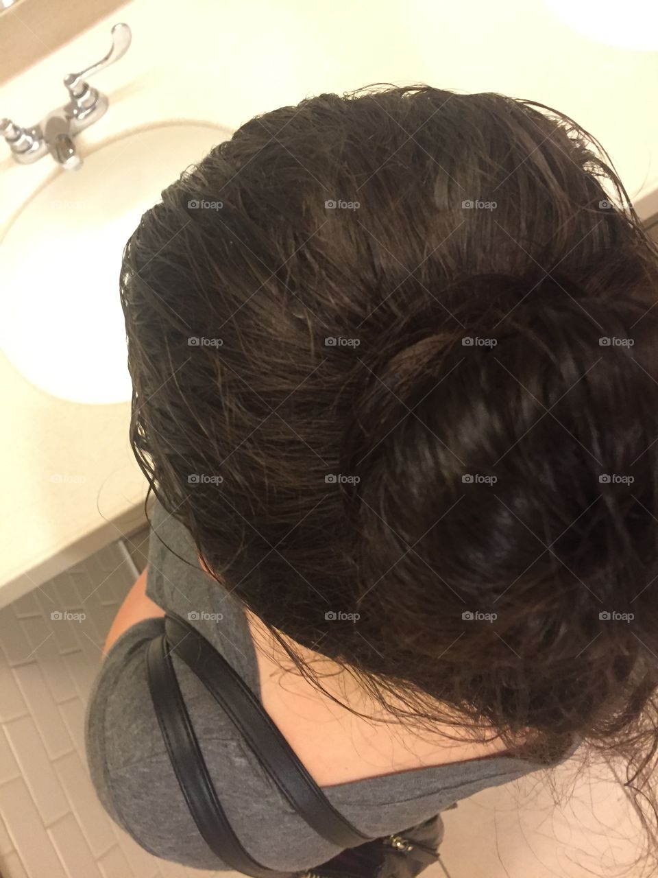 Top view of my hair bun it was also taken at a public bathroom 