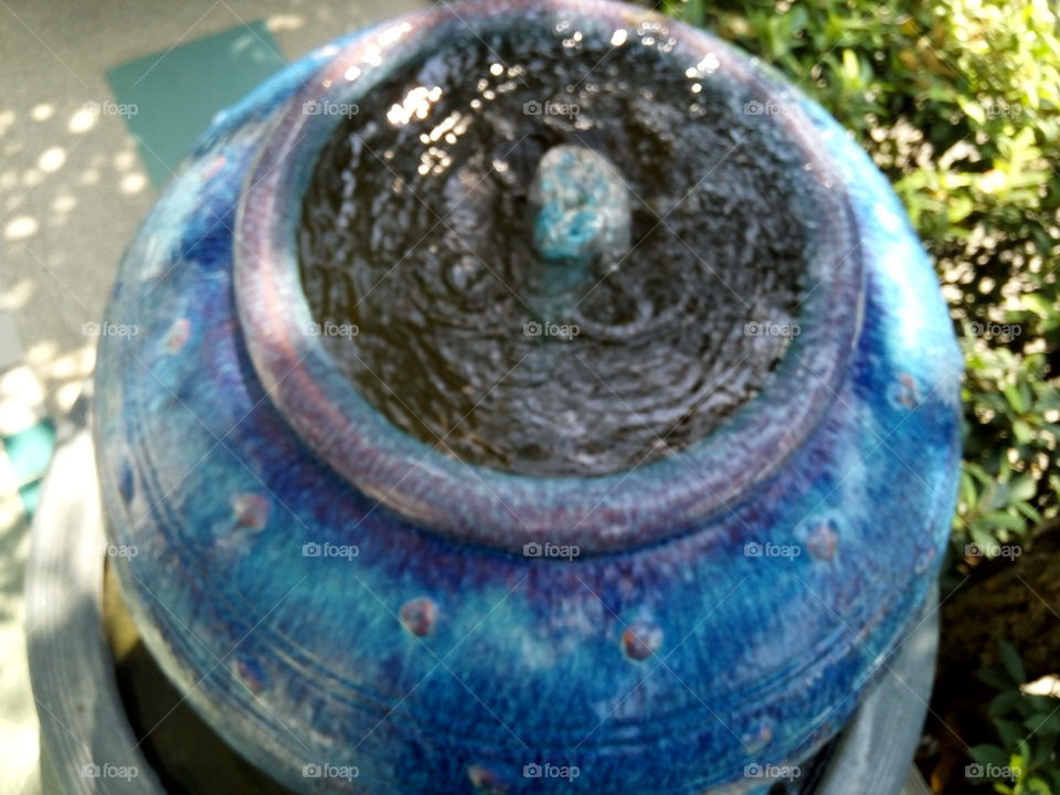 top view of big blue jar pouring out water