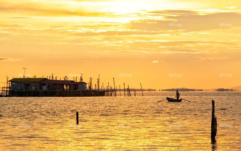 Scenic sunset with fisherman traditional going to home