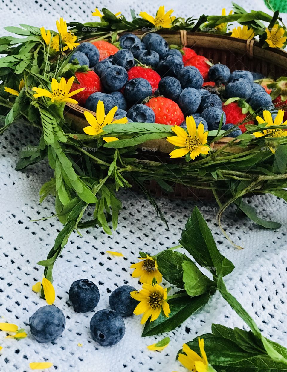 Blueberries and strawberry with yellow flower basket