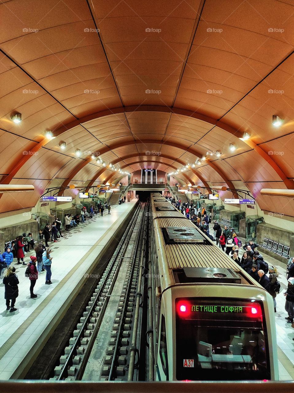 A beautiful photo of an underground station in the capital of Bulgaria with its people going to work and waiting for the train