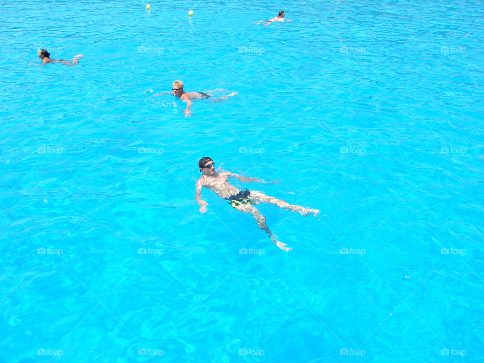 People swimming in swimming pool