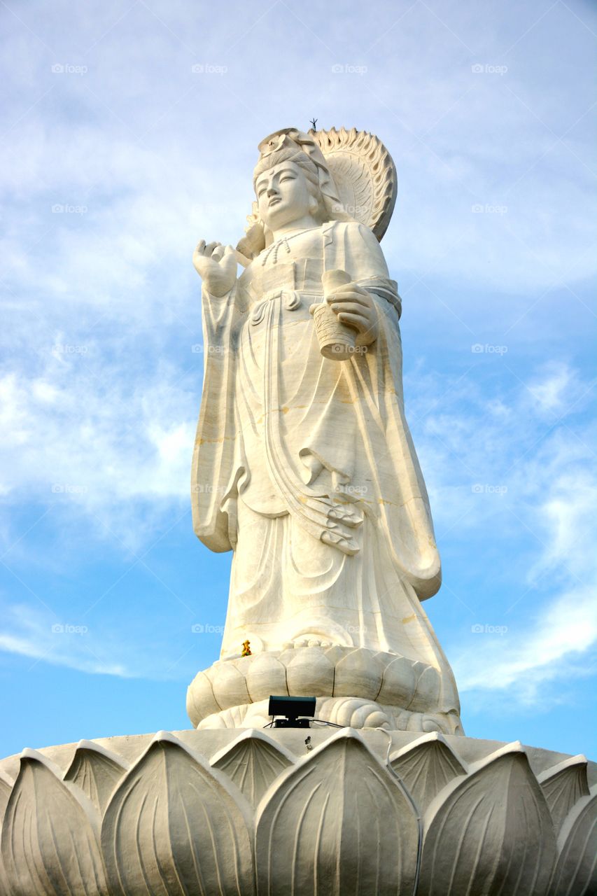 Statue of Kuan in sky background