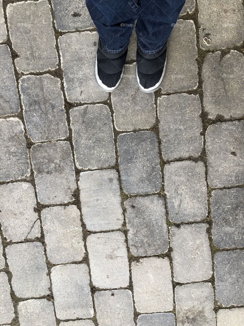 Boots on cobblestone pavement