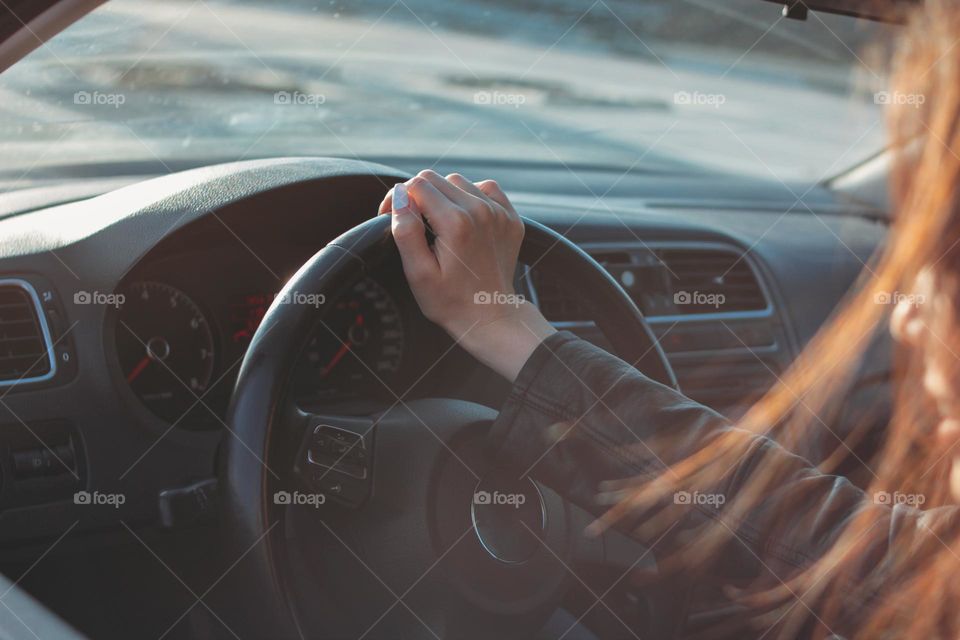 Young brunette long hair woman driving passenger car