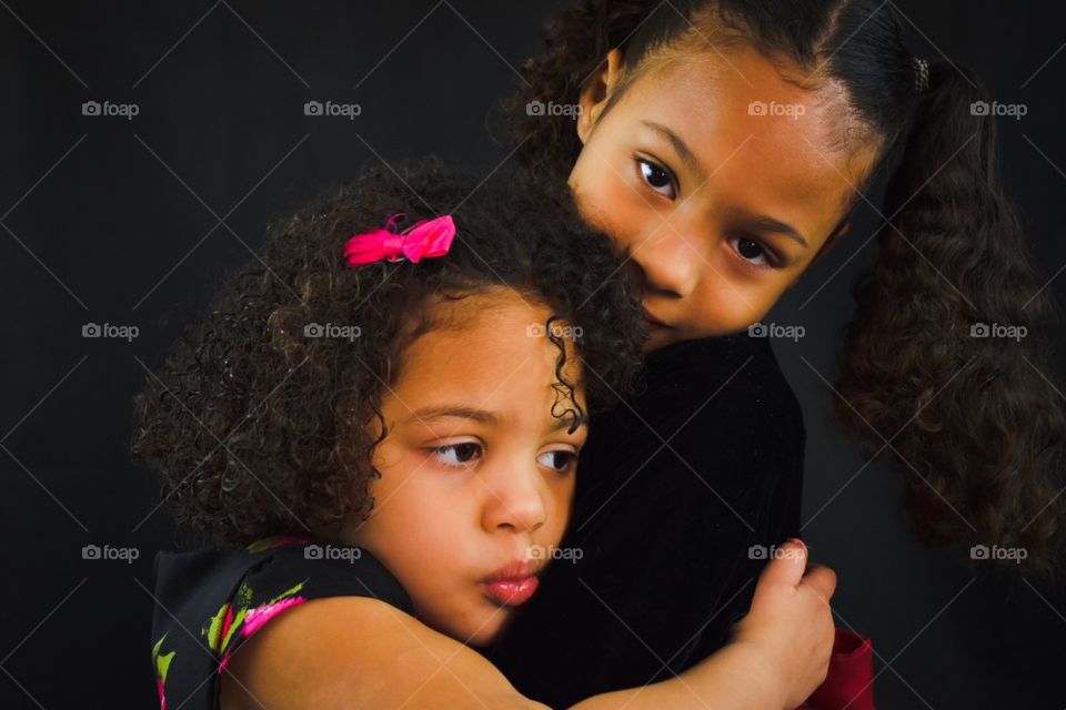 Cute sister hugging each other