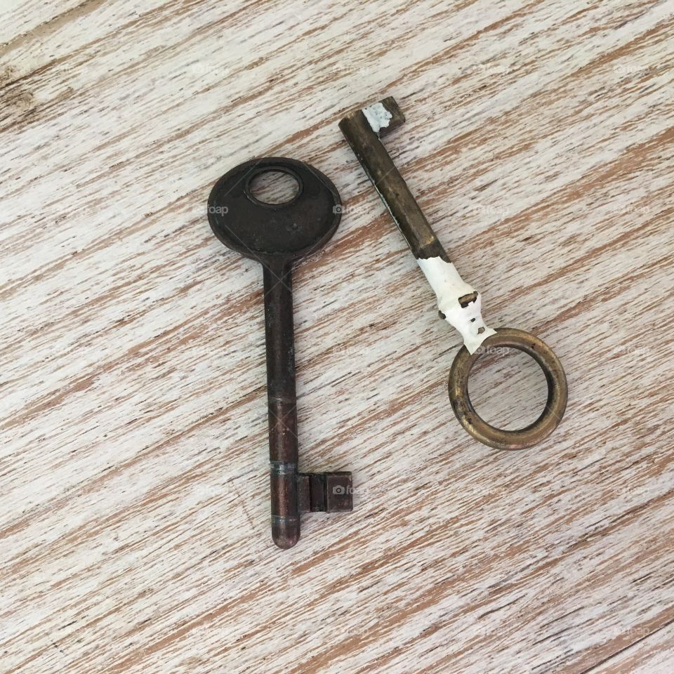 Old metal keys on wooden table