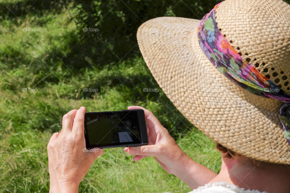 Phone. Camera phoneTourist taking a picture with a smartphone cell phone mobile phone camera 