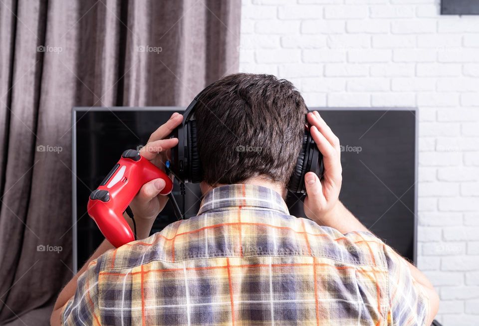 young emotional man playing video games