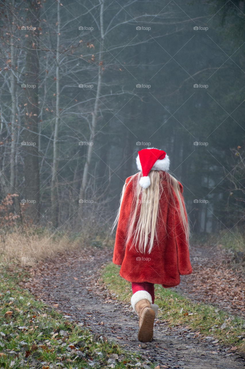 A Girl Walking in the Foggy Forest
